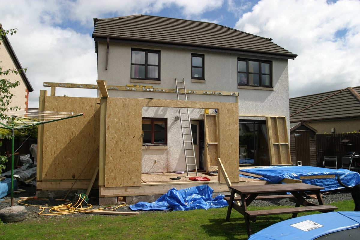 A modern home with a new extension being built